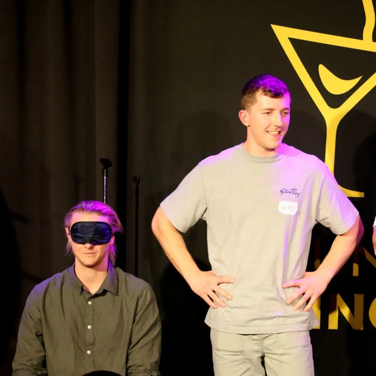 guys having a laugh at a singles event. Blind date game show for singles.